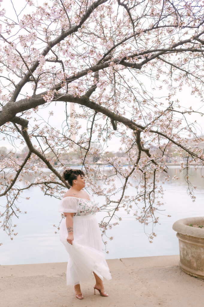 LGBTQ+ couple kissing under the cherry blossoms in Washington, DC for a wedding anniversary session by fine art wedding photographer Kathleen Marie Ward Photography